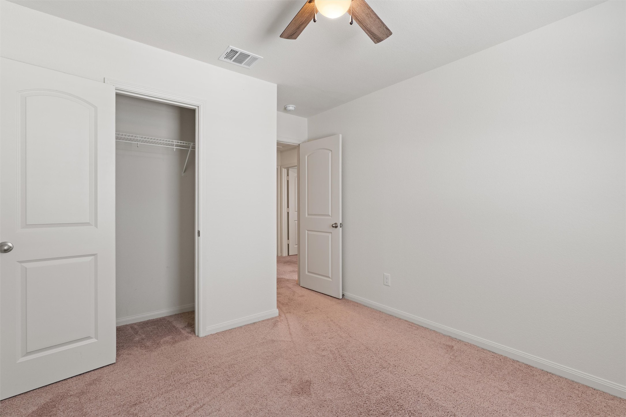 163 Niven Path, Unit 12K Jarrell, TX 76537 - Photo 23 of 31 an empty room with ceiling fan and window