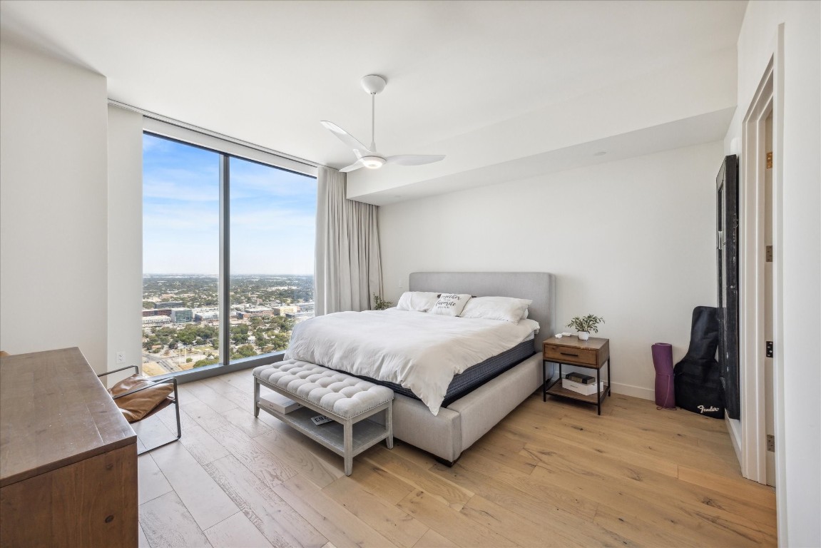 44 East Avenue, Unit 4203 Austin, TX 78701 - Photo 14 of 26 a spacious bedroom with a bed and a large window