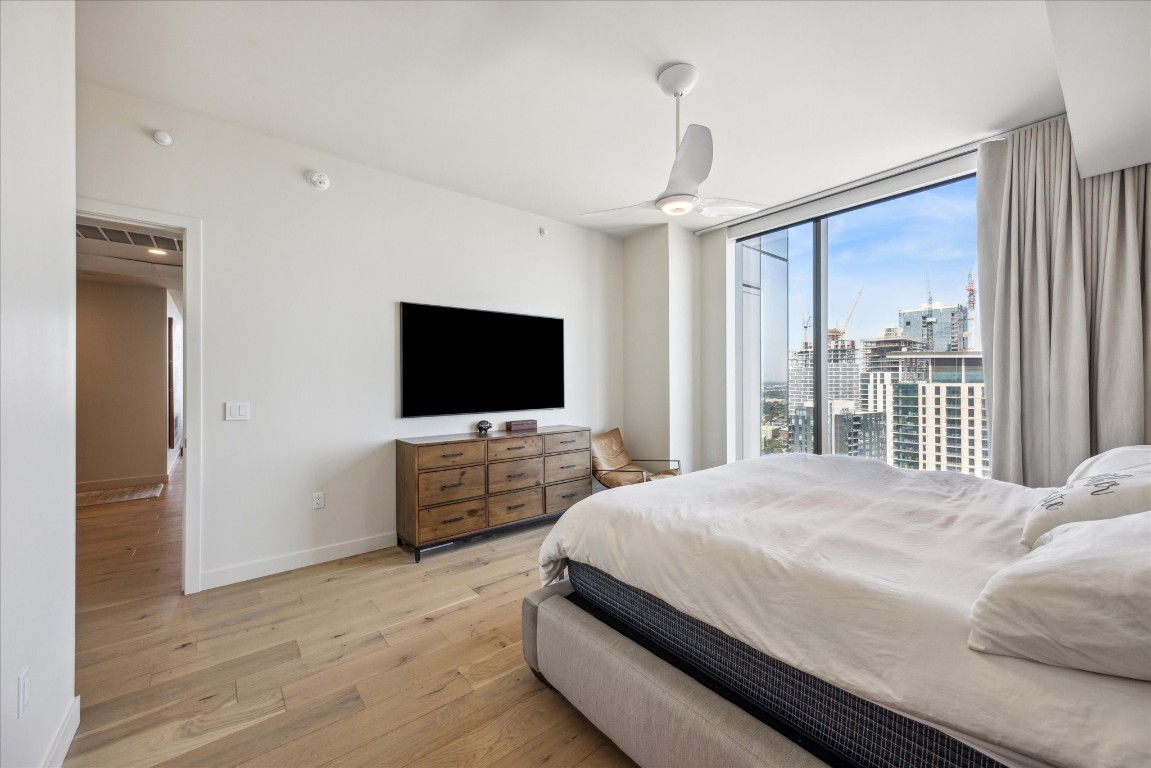 44 East Avenue, Unit 4203 Austin, TX 78701 - Photo 15 of 26 a bedroom with a bed and a flat screen tv