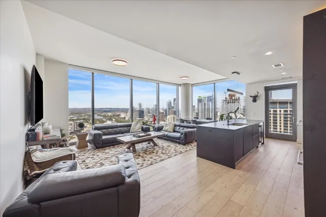 a living room with furniture and large windows