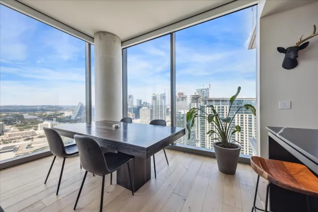 a dining room with furniture a chandelier and wooden floor