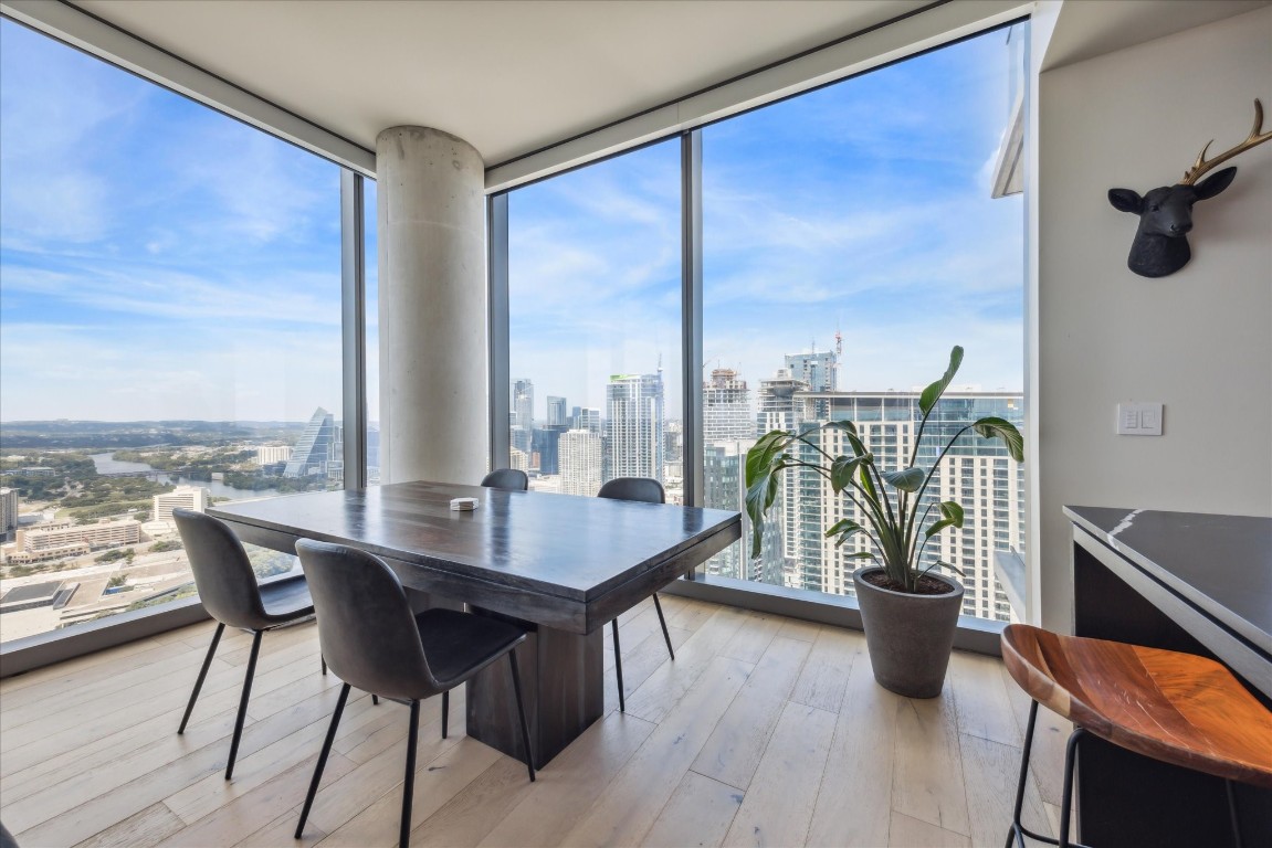 44 East Avenue, Unit 4203 Austin, TX 78701 - Photo 5 of 26 a dining room with furniture a chandelier and wooden floor