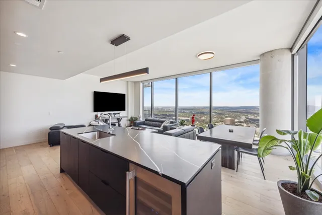 a kitchen with sink attached with living room