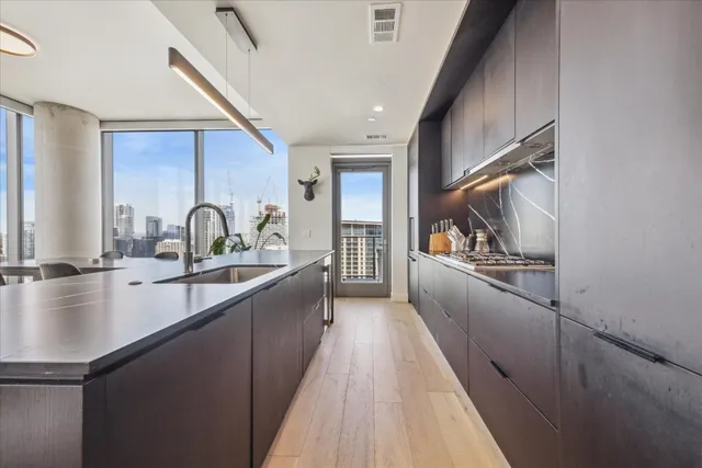a kitchen with sink a counter and cabinets