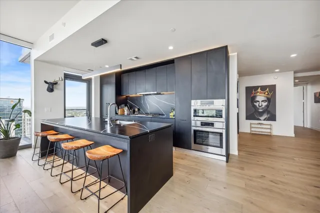 a kitchen with stainless steel appliances granite countertop a stove and a refrigerator