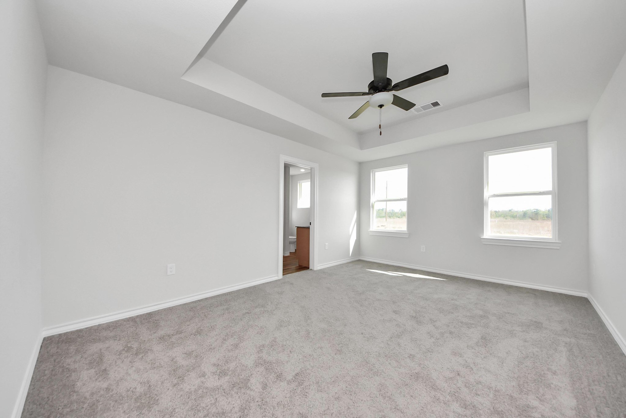 25740 John Wayne Drive Splendora, TX 77372 - Photo 24 of 48 an empty room with windows and fan