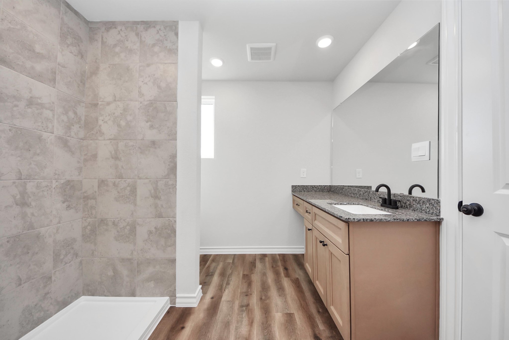 25740 John Wayne Drive Splendora, TX 77372 - Photo 29 of 48 a bathroom with a granite countertop sink a toilet and shower