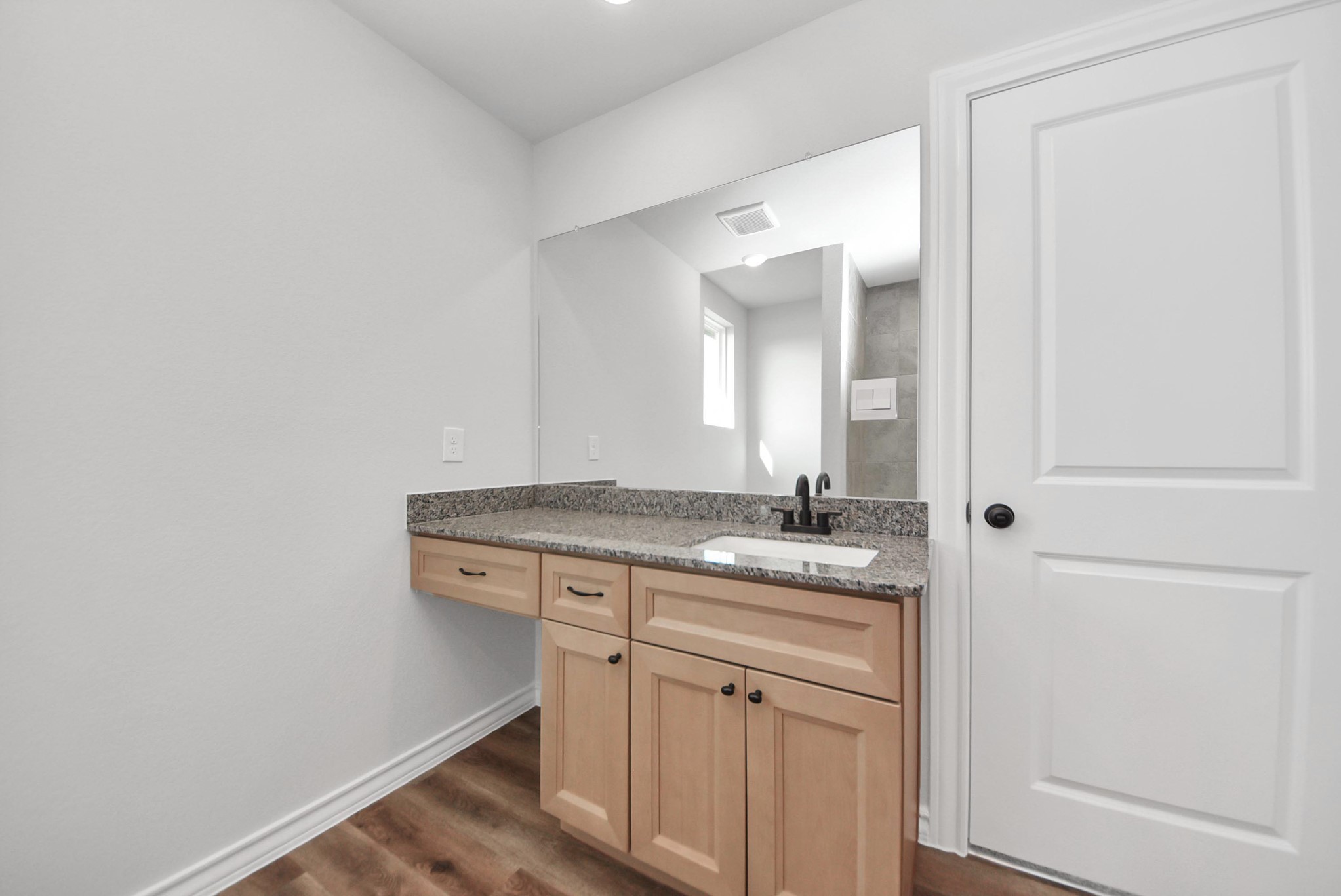 25740 John Wayne Drive Splendora, TX 77372 - Photo 30 of 48 a bathroom with a granite countertop sink and a mirror