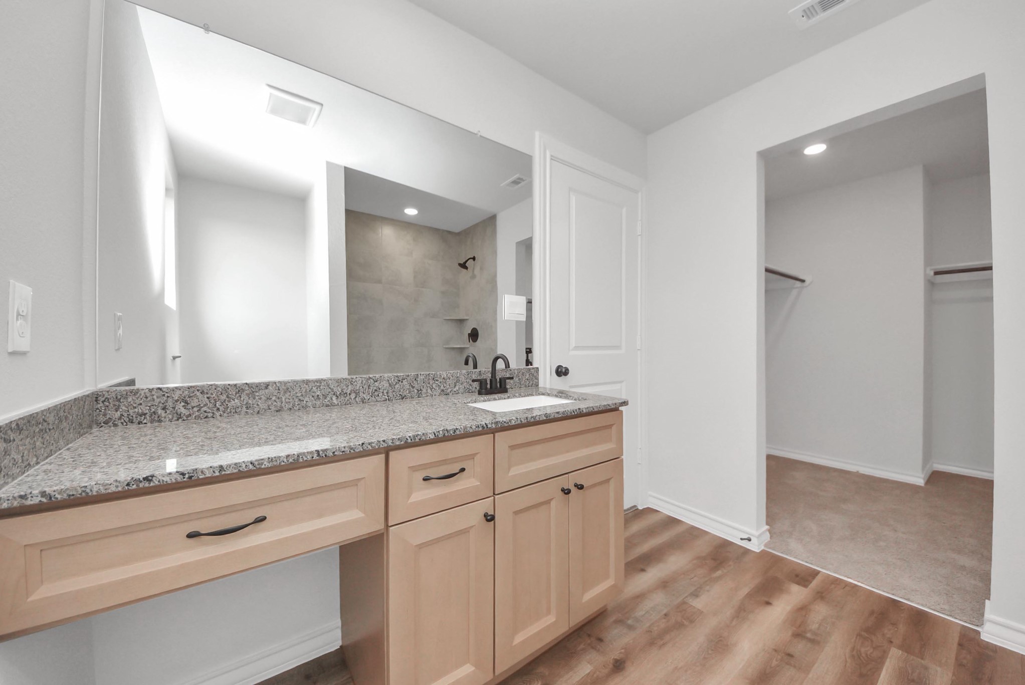 25740 John Wayne Drive Splendora, TX 77372 - Photo 32 of 48 a bathroom with a granite countertop sink and a mirror