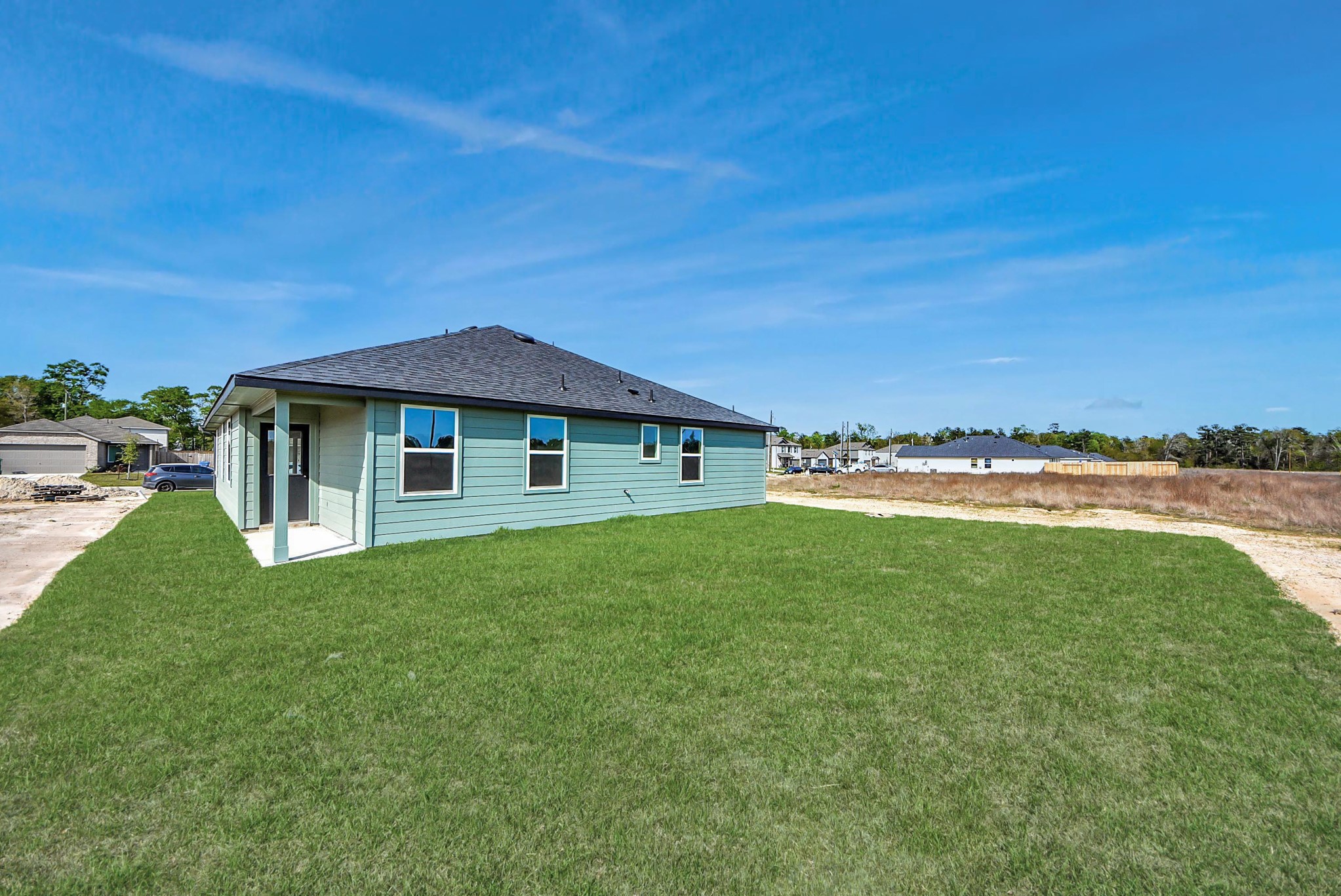 25740 John Wayne Drive Splendora, TX 77372 - Photo 43 of 48 a view of a house with a backyard
