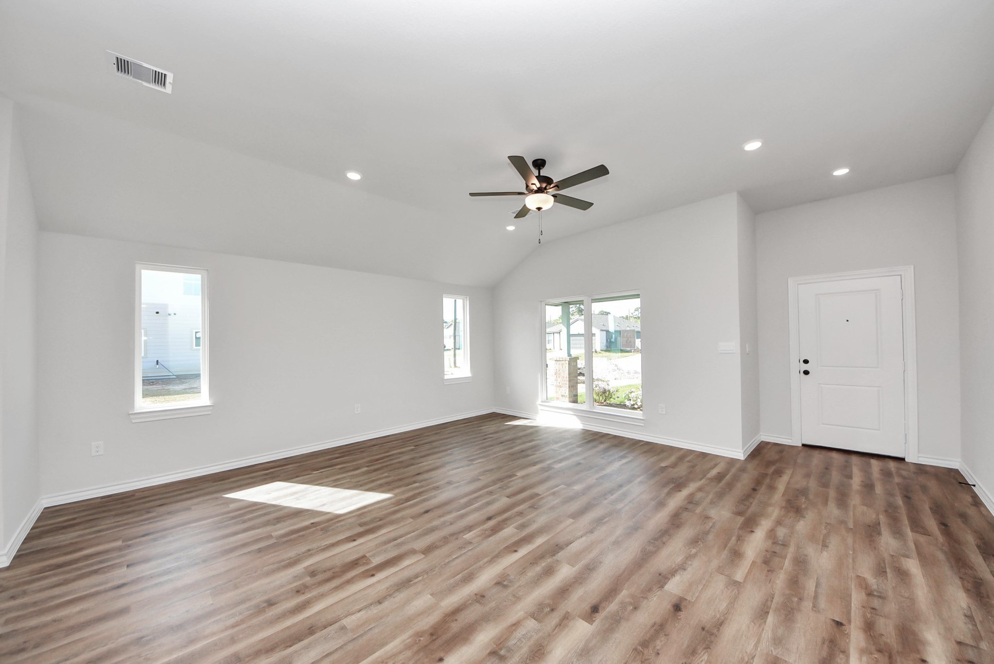 25740 John Wayne Drive Splendora, TX 77372 - Photo 8 of 48 a view of an empty room with a window and wooden floor