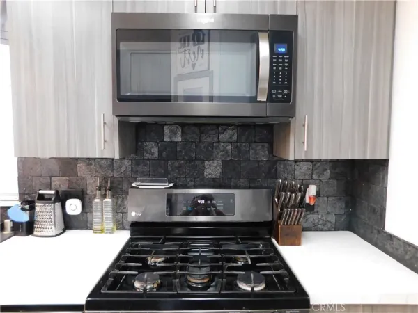 a kitchen with a stove and cabinets