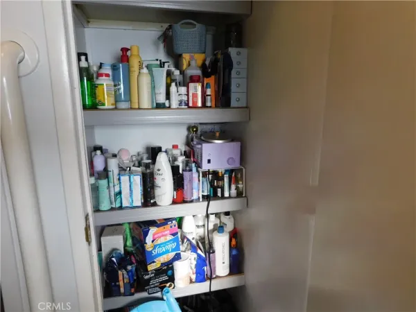 a view of closet with clothes and shoes