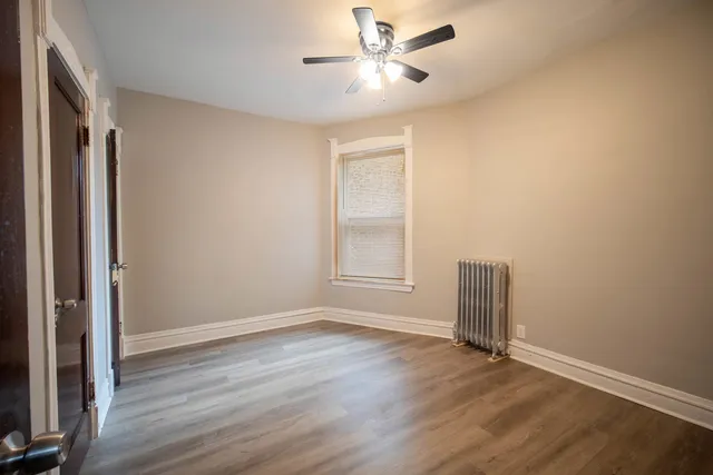 a view of room with hardwood floor and ceiling fan