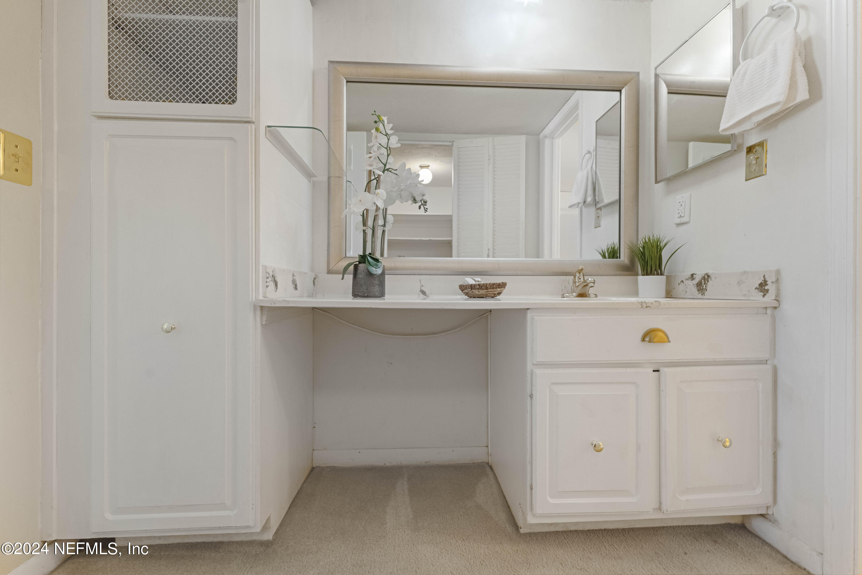 10 10th Street, Unit 17 Atlantic Beach, FL 32233 - Photo 12 of 60 a bathroom with a sink and a mirror