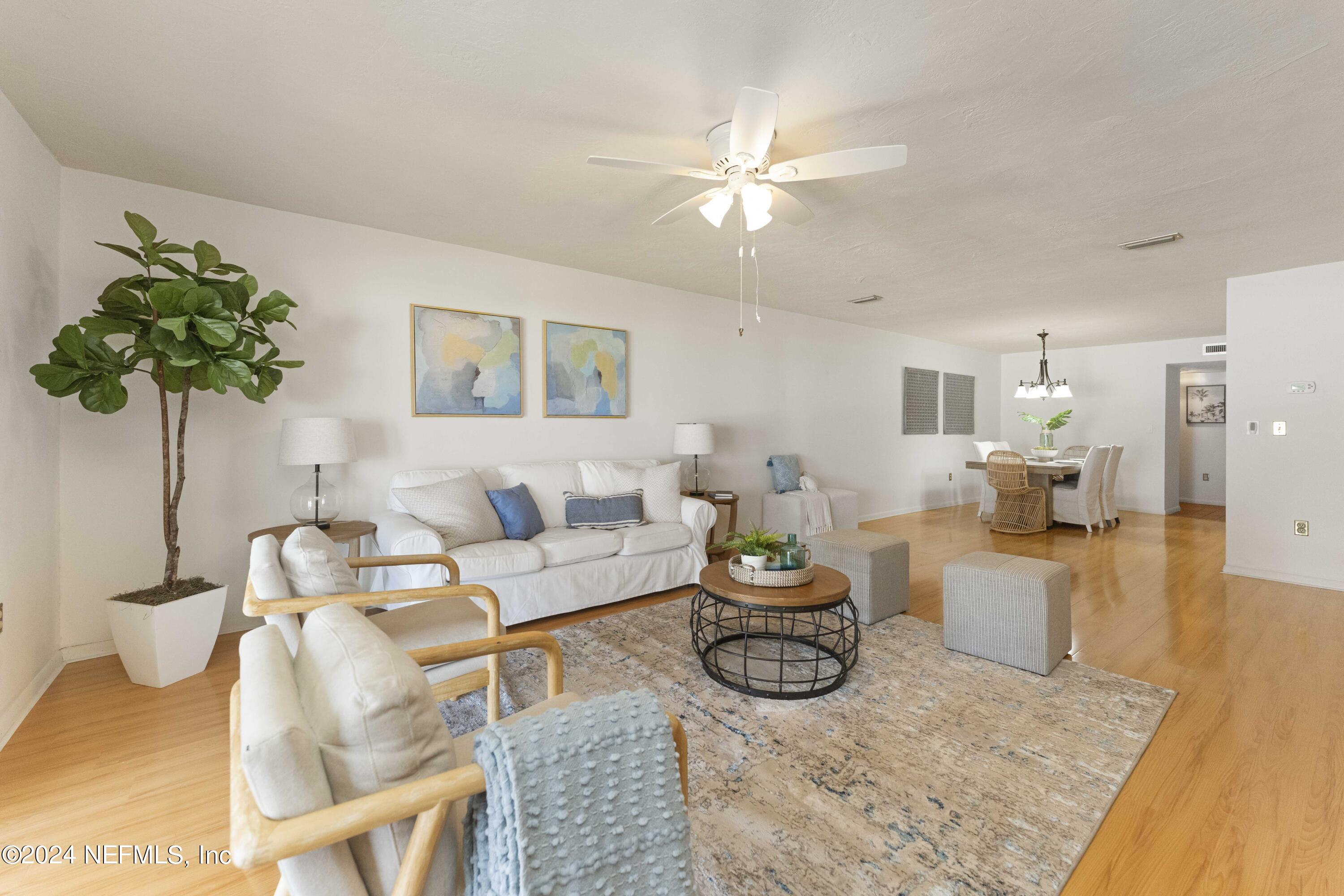 10 10th Street, Unit 17 Atlantic Beach, FL 32233 - Photo 14 of 60 a living room with furniture and a chandelier