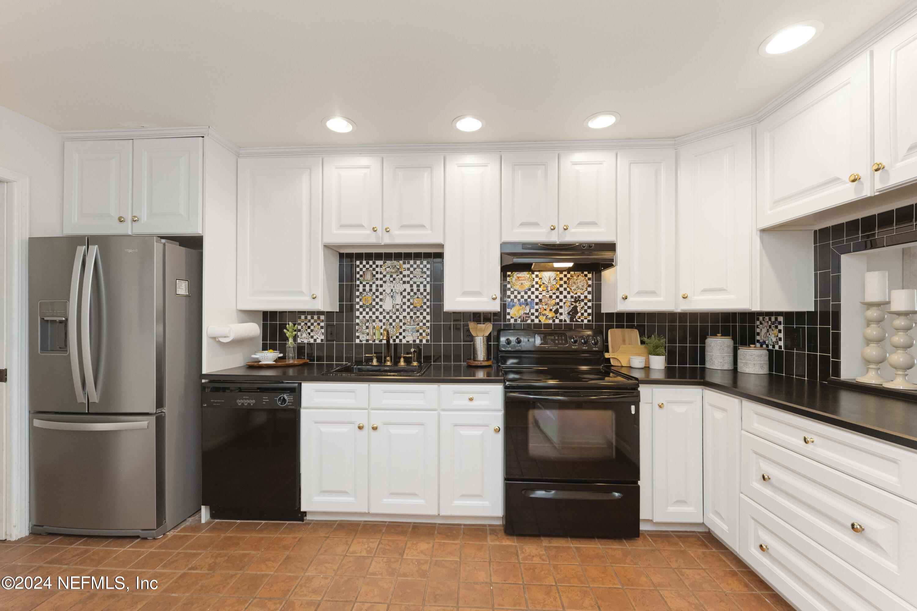 10 10th Street, Unit 17 Atlantic Beach, FL 32233 - Photo 18 of 60 a kitchen with a sink stainless steel appliances and cabinets