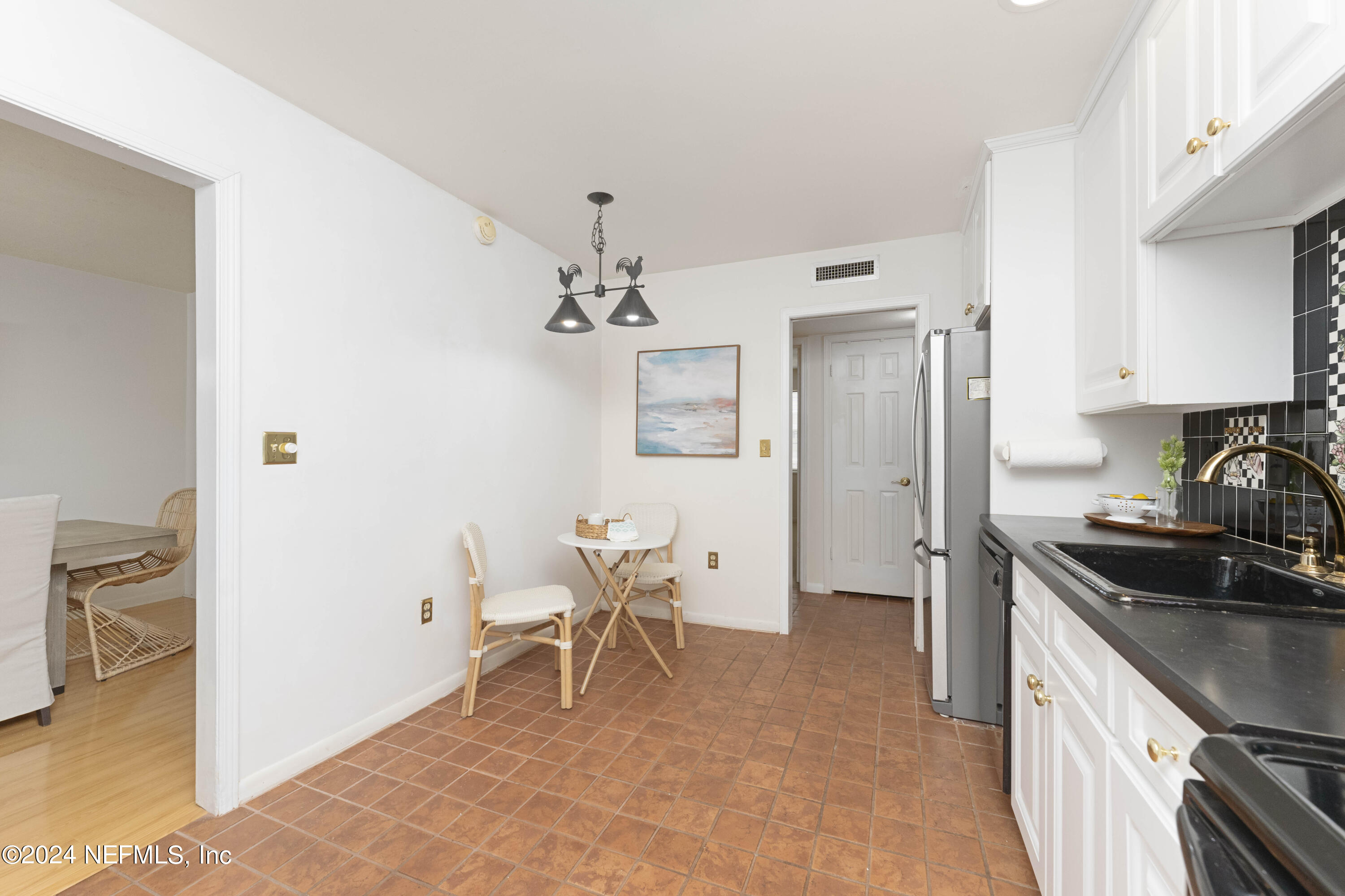 10 10th Street, Unit 17 Atlantic Beach, FL 32233 - Photo 21 of 60 a kitchen with a sink cabinets and refrigerator