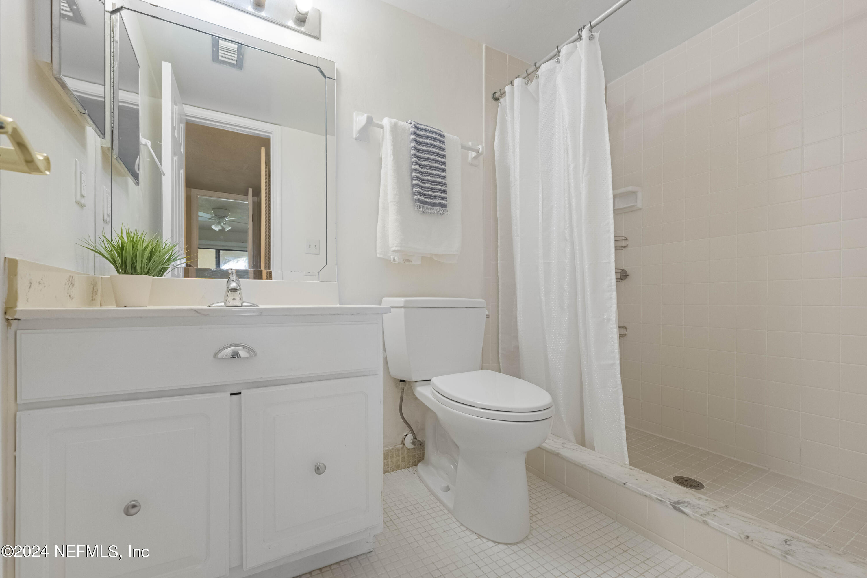 10 10th Street, Unit 17 Atlantic Beach, FL 32233 - Photo 24 of 60 a bathroom with a sink a toilet and shower
