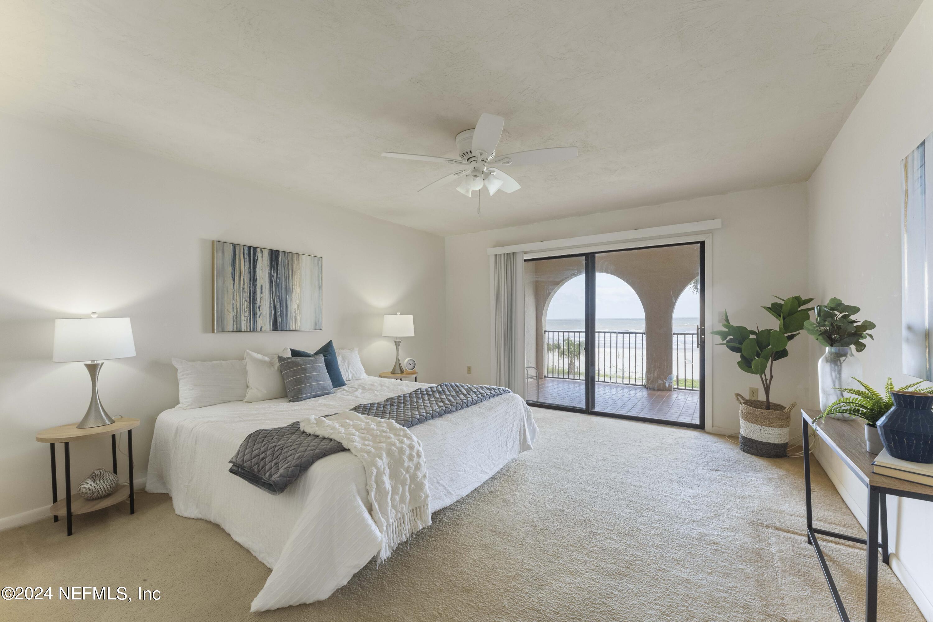 10 10th Street, Unit 17 Atlantic Beach, FL 32233 - Photo 5 of 60 a spacious bedroom with a large bed and a potted plant