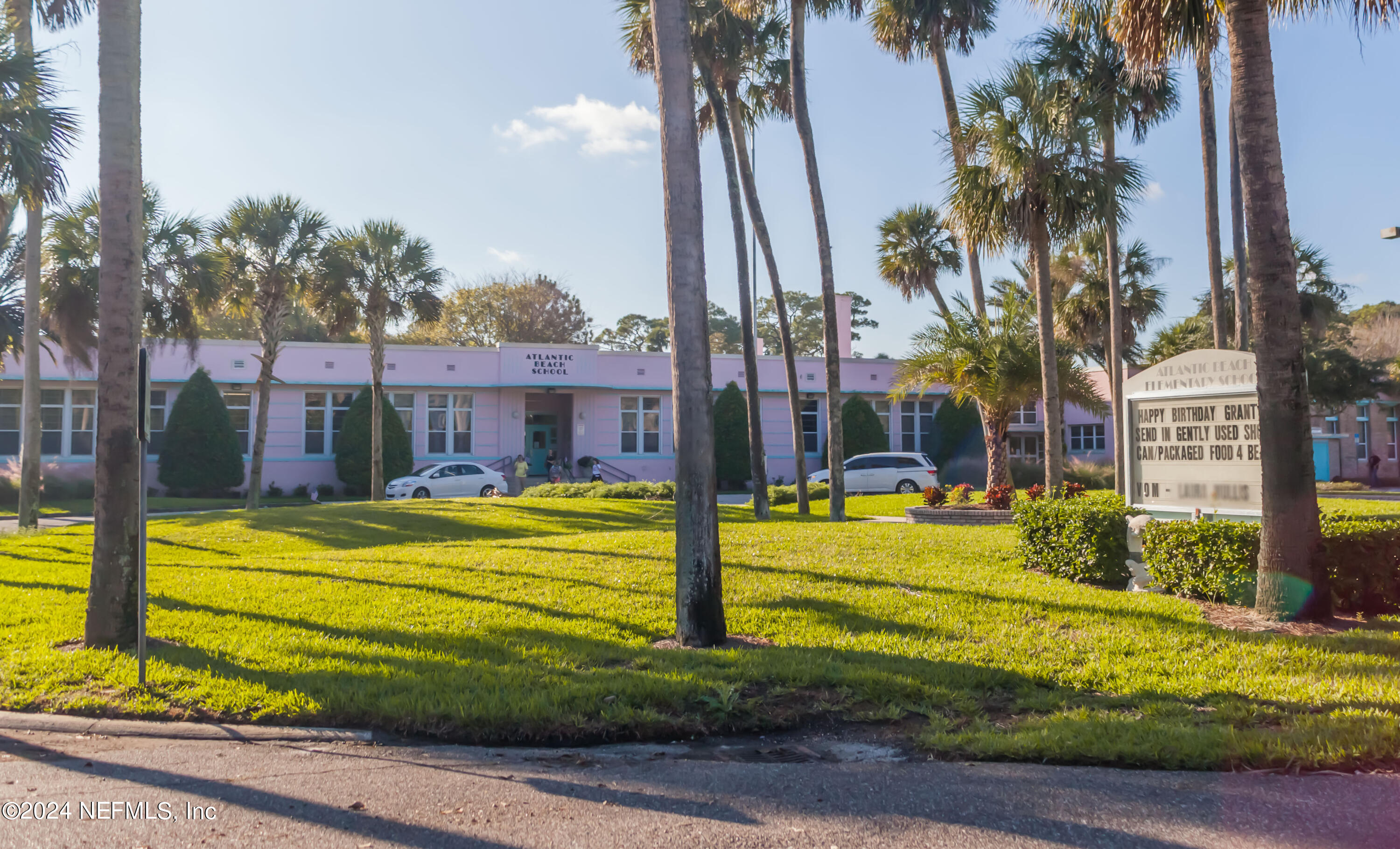 10 10th Street, Unit 17 Atlantic Beach, FL 32233 - Photo 52 of 60 a view of a swimming pool with a yard and palm trees