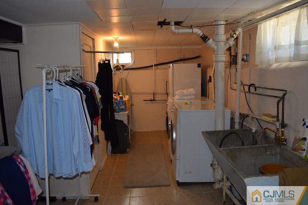 1087 Sayre Road South Union, NJ 07083 - Photo 11 of 20 a view of walk in closet with clothes and shoes