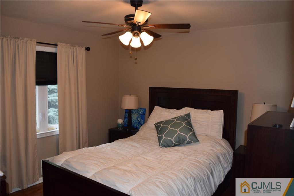 1087 Sayre Road South Union, NJ 07083 - Photo 15 of 20 a bedroom with a bed and a chandelier