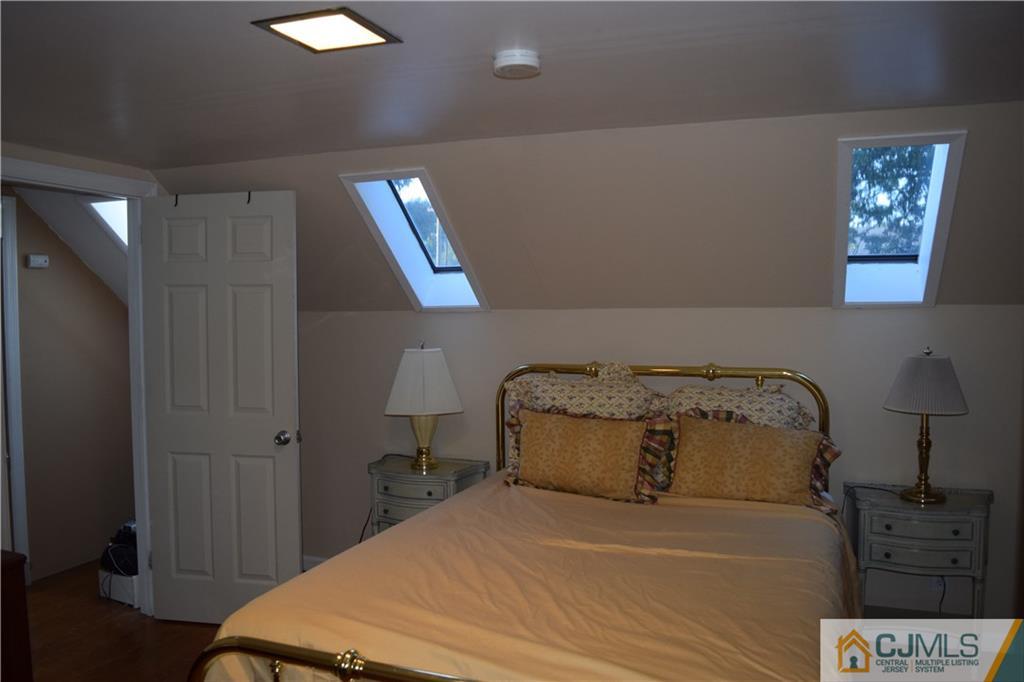 1087 Sayre Road South Union, NJ 07083 - Photo 16 of 20 a bedroom with a bed and a lamp