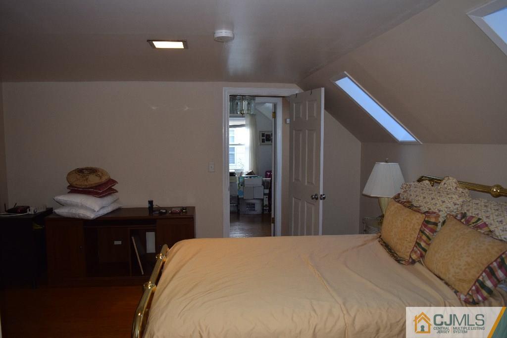 1087 Sayre Road South Union, NJ 07083 - Photo 17 of 20 a bedroom with a bed and a table in it