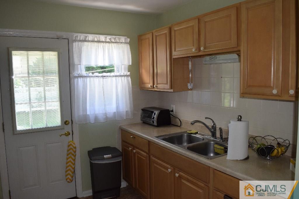 1087 Sayre Road South Union, NJ 07083 - Photo 5 of 20 a kitchen with a sink a refrigerator and window