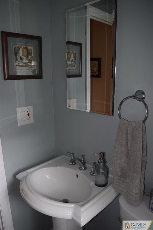 1087 Sayre Road South Union, NJ 07083 - Photo 10 of 20 a bathroom with a sink and a toilet