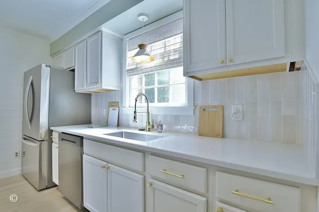 a kitchen with stainless steel appliances granite countertop a refrigerator sink and cabinets