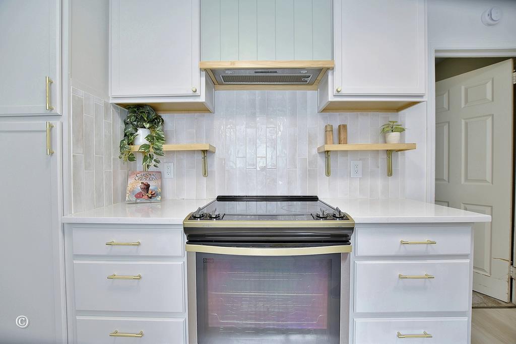 4201 Forrest Road Columbus, GA 31907 - Photo 16 of 31 Kitchen Range and Tile Backsplash