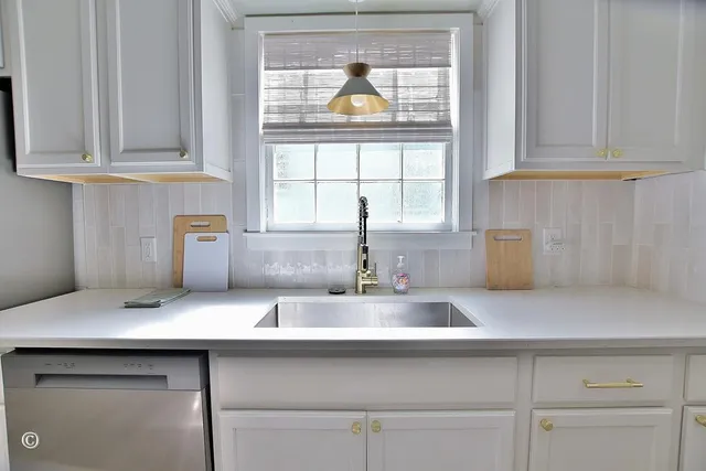a kitchen with a sink and a window