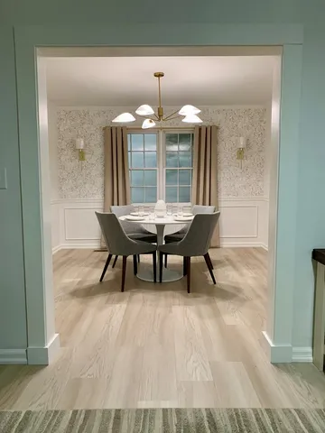 a dining room with furniture and window