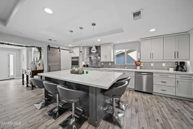 a view of a dining room with furniture wooden floor and a chandelier