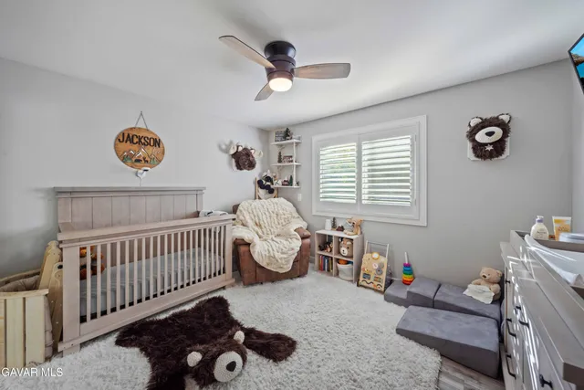 a room with gym equipment and wooden floor