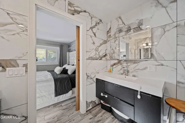 a bedroom with a large bed and a window