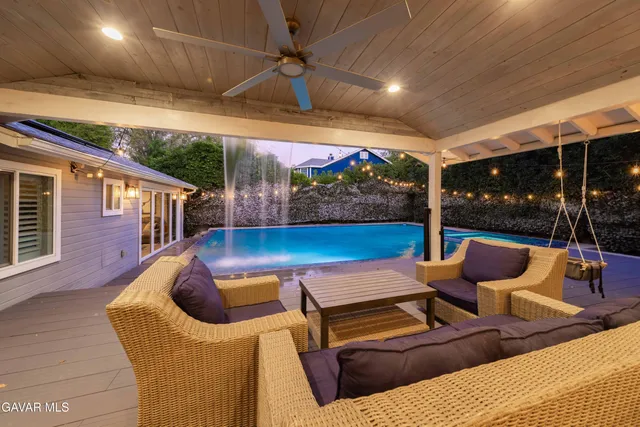 a kitchen with a stove a sink dishwasher a kitchen island with wooden cabinets and floor