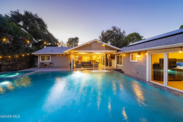 a bathroom with a granite countertop sink toilet and mirror