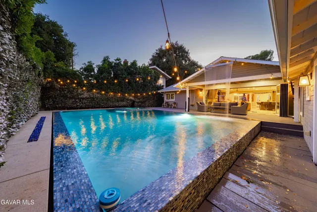a bedroom with a bed and a view of kitchen
