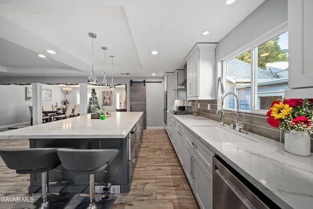 a large kitchen with a table and chairs