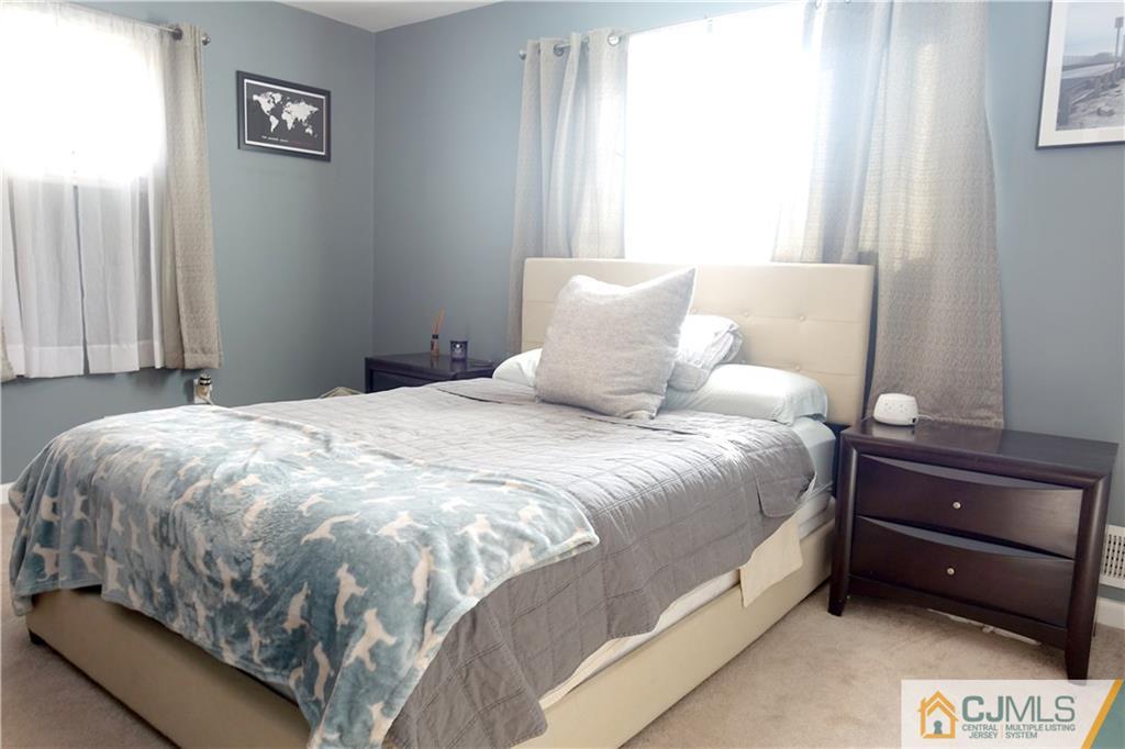 194 McFarlane Road Colonia, NJ 07067 - Photo 12 of 16 a large bed sitting in a bedroom next to a window