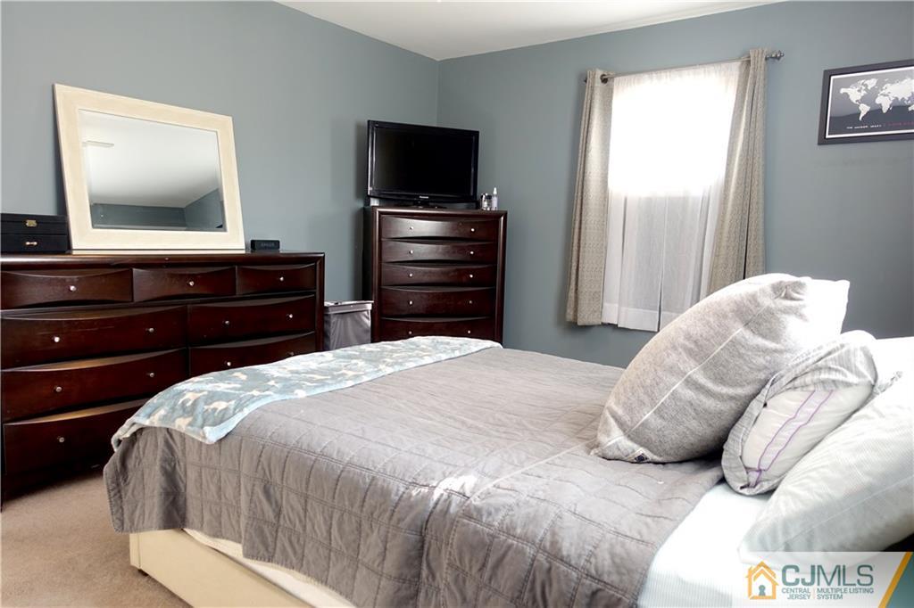 194 McFarlane Road Colonia, NJ 07067 - Photo 13 of 16 a bedroom with a bed and a flat screen tv
