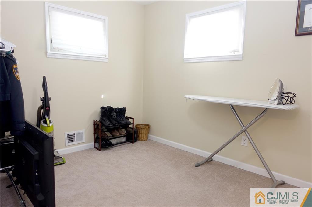 194 McFarlane Road Colonia, NJ 07067 - Photo 14 of 16 a room with gym equipment and a window