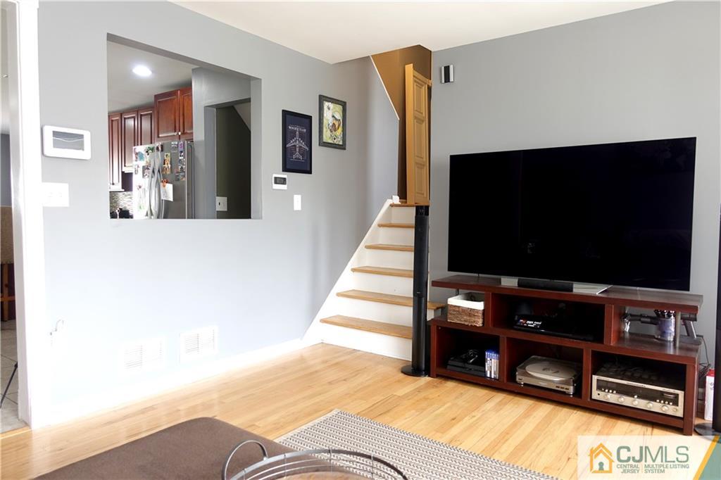 194 McFarlane Road Colonia, NJ 07067 - Photo 4 of 16 a living room with furniture and a flat screen tv