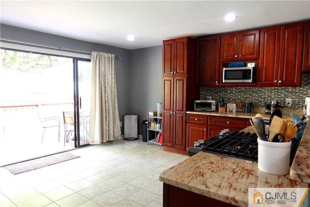 194 McFarlane Road Colonia, NJ 07067 - Photo 6 of 16 a kitchen with a stove a sink and a microwave