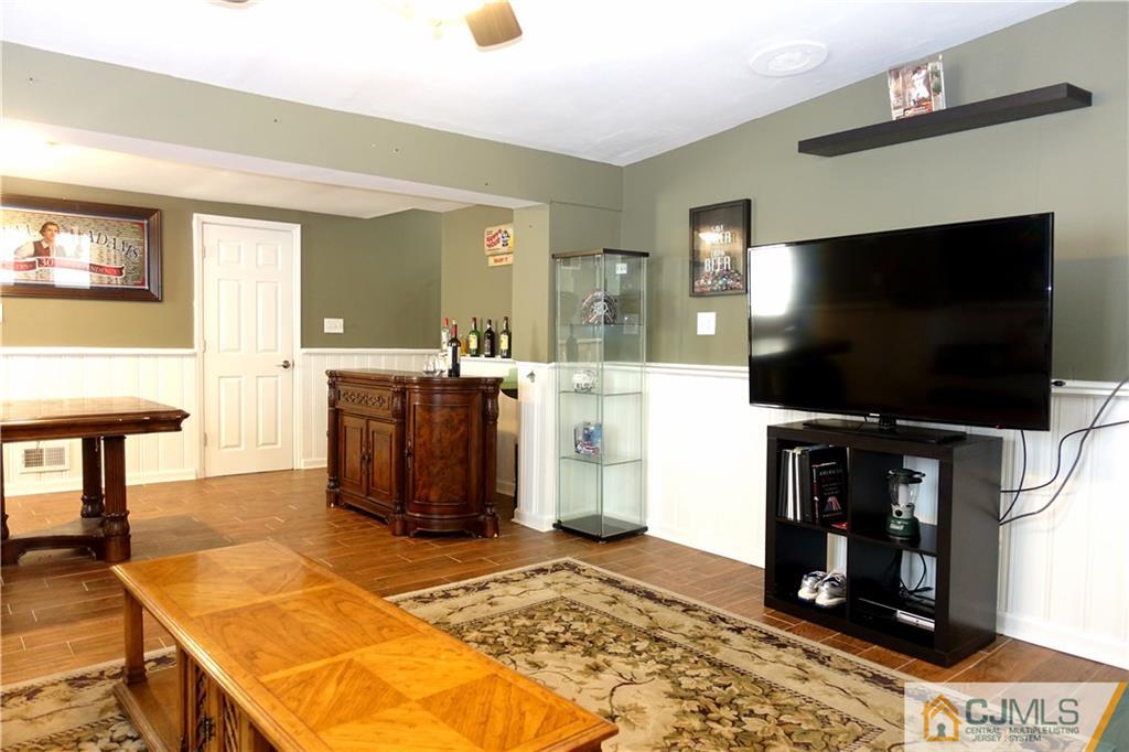 194 McFarlane Road Colonia, NJ 07067 - Photo 10 of 16 a living room with flat screen tv and a table