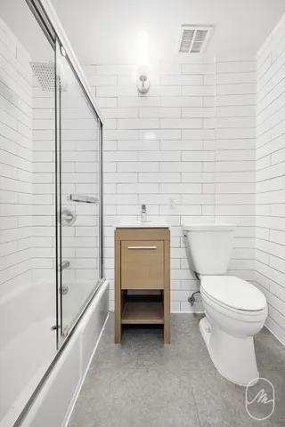 a bathroom with a toilet a sink and mirror