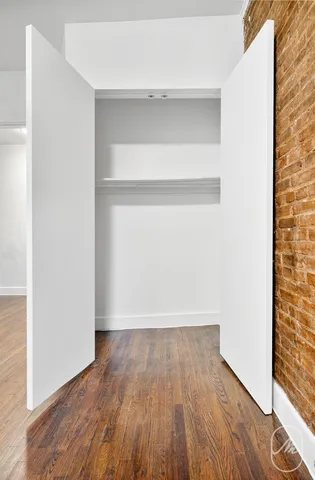 a view of a room with wooden floor